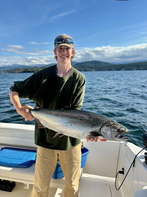 Young angler holding a Chinook salmon near Nanoose Bay